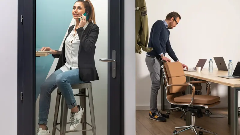 Une personne au téléphone dans la cabine, un coworker à son bureau